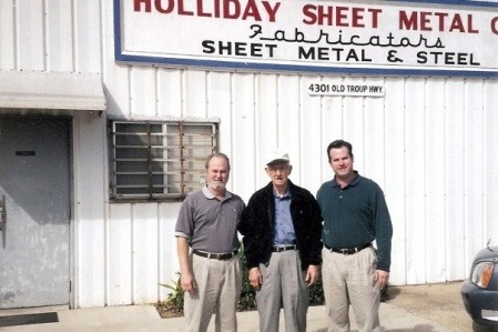 Holliday Sheet Metal Family in front of Shop.