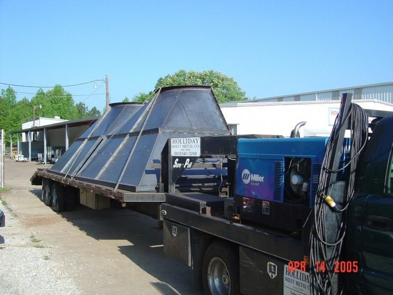 A large truck with a solar panel on the back.