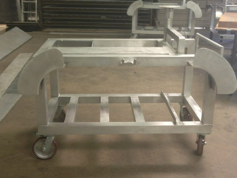 A metal cart with wheels and two trays on top.