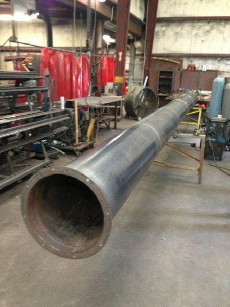 A large metal pipe sitting in the middle of a room.
