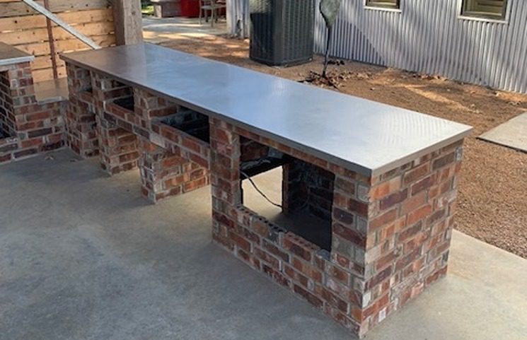An outdoor counter with steel using metal fabrication.